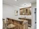 Basement bar area featuring wooden cabinets, granite countertops, and a stainless steel sink at 604 Timm Valley Ne Rd # A, Atlanta, GA 30305
