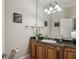 Bathroom featuring a vanity with granite countertop, decorative mirror and artwork at 604 Timm Valley Ne Rd # A, Atlanta, GA 30305