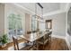 Sunlit dining room featuring hardwood floors, large windows, and stylish light fixture at 604 Timm Valley Ne Rd # A, Atlanta, GA 30305