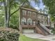 Elegant brick home featuring a well-manicured lawn, attached garage, and welcoming front porch at 604 Timm Valley Ne Rd # A, Atlanta, GA 30305