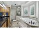 Main bathroom featuring double sinks, soaking tub, tiled shower, and luxurious finishes at 604 Timm Valley Ne Rd # A, Atlanta, GA 30305