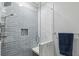 Bathroom shower with gray tile, a glass enclosure, and a built-in soap nook at 604 Timm Valley Ne Rd # A, Atlanta, GA 30305