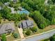 Expansive aerial view of the property showcasing lush landscaping, a pool, and a tennis court at 1393 Kings Park Nw Dr, Kennesaw, GA 30152