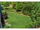 Manicured backyard with lush lawn and mature landscaping for privacy at 1393 Kings Park Nw Dr, Kennesaw, GA 30152