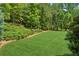 A verdant lawn and mature landscaping provide a serene backdrop at 1393 Kings Park Nw Dr, Kennesaw, GA 30152