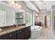 The primary bathroom features granite countertops, a soaking tub, and large windows at 1393 Kings Park Nw Dr, Kennesaw, GA 30152