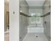 The glass enclosed shower features tile walls, a tiled bench and a window at 1393 Kings Park Nw Dr, Kennesaw, GA 30152
