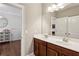 Bright bathroom featuring double vanity sinks and modern finishes with view to bedroom at 1393 Kings Park Nw Dr, Kennesaw, GA 30152
