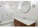 Modern bathroom featuring a glass-enclosed shower, stylish vanity with a round mirror, and sleek fixtures at 1393 Kings Park Nw Dr, Kennesaw, GA 30152
