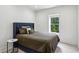 Neutral bedroom with a blue upholstered bed frame and white trim, offering a calming space at 1393 Kings Park Nw Dr, Kennesaw, GA 30152