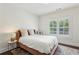 Bright bedroom featuring hardwood floors, a comfortable bed, and a window with blinds at 1393 Kings Park Nw Dr, Kennesaw, GA 30152