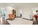 Bright bedroom with an orange rocking chair, hardwood floors, and views into other rooms at 1393 Kings Park Nw Dr, Kennesaw, GA 30152
