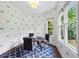 Bright breakfast nook featuring windows and patterned wallpaper with a table and seating for casual dining at 1393 Kings Park Nw Dr, Kennesaw, GA 30152