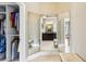 Bright walk-in closet features ample storage and mirrored dressing area leading to the bathroom at 1393 Kings Park Nw Dr, Kennesaw, GA 30152