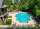 A large community pool is surrounded by mature landscaping and lounge chairs at 1393 Kings Park Nw Dr, Kennesaw, GA 30152