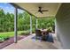 Charming covered patio features ceiling fan, outdoor dining set, and manicured garden views at 1393 Kings Park Nw Dr, Kennesaw, GA 30152
