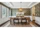 Formal dining room with decorative wallpaper, coffered ceilings, large windows and decorative lighting at 1393 Kings Park Nw Dr, Kennesaw, GA 30152