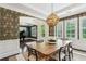 Open dining room showcasing elegant wallpaper, dark hardwood flooring, and abundant natural light at 1393 Kings Park Nw Dr, Kennesaw, GA 30152