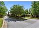 Welcoming entrance to the community with mature trees and manicured landscaping at 1393 Kings Park Nw Dr, Kennesaw, GA 30152