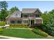 Beautiful brick home with manicured lawn and mature trees, offering classic elegance and curb appeal at 1393 Kings Park Nw Dr, Kennesaw, GA 30152