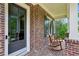 Inviting front porch with rocking chairs, brick accents, and a secure smart lock at 1393 Kings Park Nw Dr, Kennesaw, GA 30152