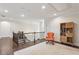 Hallway space with hardwood floors, area rug, comfy chair and built in shelving at 1393 Kings Park Nw Dr, Kennesaw, GA 30152