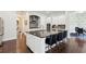 Modern kitchen featuring a large island with seating, granite countertops, and stainless steel appliances at 1393 Kings Park Nw Dr, Kennesaw, GA 30152