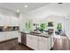 Bright, open-concept kitchen with a large island, granite countertops, and seamless flow into the living area at 1393 Kings Park Nw Dr, Kennesaw, GA 30152