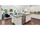Spacious kitchen with a large center island, granite countertops, and open view to the living room at 1393 Kings Park Nw Dr, Kennesaw, GA 30152