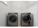 Modern laundry room features side-by-side, front-load washer and dryer, perfect for convenience at 1393 Kings Park Nw Dr, Kennesaw, GA 30152