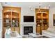 Inviting living room featuring built-in shelves, a cozy fireplace, and comfortable seating at 1393 Kings Park Nw Dr, Kennesaw, GA 30152
