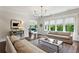 Sunlit living room featuring hardwood floors, neutral walls, and comfortable seating arrangements at 1393 Kings Park Nw Dr, Kennesaw, GA 30152
