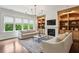 Cozy living room featuring a fireplace, built-in shelving, and comfortable seating for relaxation at 1393 Kings Park Nw Dr, Kennesaw, GA 30152