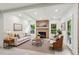 Cozy living room featuring a brick fireplace, a sofa, chairs, and lots of natural light at 1393 Kings Park Nw Dr, Kennesaw, GA 30152