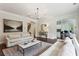 Spacious living room with neutral walls, hardwood floors, and comfortable seating arrangements at 1393 Kings Park Nw Dr, Kennesaw, GA 30152