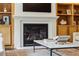 Cozy living room features a modern fireplace, built-in shelves, and a sleek coffee table at 1393 Kings Park Nw Dr, Kennesaw, GA 30152