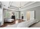 View of the primary bedroom featuring a seating area, hardwood floors, and natural light at 1393 Kings Park Nw Dr, Kennesaw, GA 30152