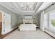 Spacious main bedroom suite featuring a tray ceiling, large window, and neutral decor at 1393 Kings Park Nw Dr, Kennesaw, GA 30152