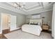 A primary bedroom features hardwood flooring, tray ceilings and neutral decor at 1393 Kings Park Nw Dr, Kennesaw, GA 30152