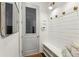 Well-organized mudroom featuring shiplap walls, a bench with storage, and convenient hooks at 1393 Kings Park Nw Dr, Kennesaw, GA 30152