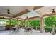 Inviting outdoor grilling area with dining space, ceiling fans, and scenic views at 1393 Kings Park Nw Dr, Kennesaw, GA 30152