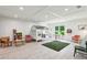 Bright playroom featuring a playhouse, a sitting area with chairs, and a table with chairs near the window at 1393 Kings Park Nw Dr, Kennesaw, GA 30152