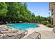 Beautiful pool surrounded by lounge chairs and lush greenery for relaxation and enjoyment at 1393 Kings Park Nw Dr, Kennesaw, GA 30152