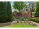 Community signage surrounded by colorful landscaping and lush greenery, adding to the neighborhood's charm at 1393 Kings Park Nw Dr, Kennesaw, GA 30152