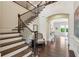 Elegant staircase featuring dark wood railings, hardwood steps, and an open floor plan at 1393 Kings Park Nw Dr, Kennesaw, GA 30152