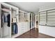 Large walk-in closet with custom built-ins, hardwood floors, and generous storage space at 1393 Kings Park Nw Dr, Kennesaw, GA 30152