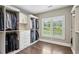 Spacious walk-in closet with custom shelving, drawers, and window for natural light at 1393 Kings Park Nw Dr, Kennesaw, GA 30152