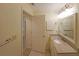 Bright bathroom featuring a granite countertop vanity and an open doorway at 1800 Clairmont Lk # 213, Decatur, GA 30033