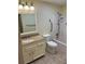 Well-lit bathroom features a granite-topped vanity, toilet, and accessible shower-tub with grab bars at 1800 Clairmont Lk # 213, Decatur, GA 30033