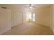 Bedroom featuring neutral carpet, three doors, and a ceiling fan at 1800 Clairmont Lk # 213, Decatur, GA 30033